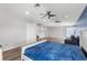 Large living area with bed, seating, wood-look floors, and multiple ceiling fans at 12925 Tar Flower Dr, Tampa, FL 33626