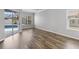 Bright living room featuring wood-look flooring, and a sliding door providing access to the pool area at 12925 Tar Flower Dr, Tampa, FL 33626