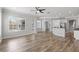 Open living space features wood-look floors and flows into the kitchen and outdoor living areas at 12925 Tar Flower Dr, Tampa, FL 33626