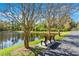 A bench sits along a walkway, offering scenic views of the pond and surrounding greenery at 12925 Tar Flower Dr, Tampa, FL 33626
