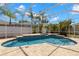 Screened-in pool area with a uniquely shaped pool, hot tub, and tropical landscaping at 12925 Tar Flower Dr, Tampa, FL 33626
