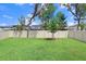 Manicured backyard featuring a well-maintained lawn and a sturdy privacy fence at 14184 Samoa Hill Ct, Riverview, FL 33569