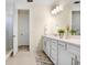 Bright bathroom featuring double sinks, plenty of counter space and a glass door shower at 14184 Samoa Hill Ct, Riverview, FL 33569