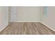 Empty bedroom showing wood flooring, and closet with window at 14184 Samoa Hill Ct, Riverview, FL 33569