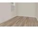 Empty room featuring wood-look flooring and a window for natural light at 14184 Samoa Hill Ct, Riverview, FL 33569
