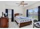 Bright bedroom features a classic wood bed, a ceiling fan, and a desk beneath a window with blinds at 14184 Samoa Hill Ct, Riverview, FL 33569