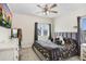 Comfortable bedroom featuring a ceiling fan, a modern bed with floral bedding, and a large dresser with mirror at 14184 Samoa Hill Ct, Riverview, FL 33569