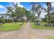Beautiful community common area with lush greenery, picnic tables, walking path, and mature trees at 14184 Samoa Hill Ct, Riverview, FL 33569