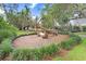 Charming community area featuring decorative logs surrounded by lush landscaping and a well-maintained lawn at 14184 Samoa Hill Ct, Riverview, FL 33569