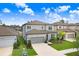 Charming two-story home featuring a two-car garage, manicured lawn, and beautiful landscaping, perfect for Gathering living at 14184 Samoa Hill Ct, Riverview, FL 33569