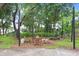 Cozy community fire pit area with Adirondack chairs, decorative lighting, and a welcoming ambiance at 14184 Samoa Hill Ct, Riverview, FL 33569