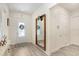Welcoming foyer featuring wood-look floors, a decorative mirror, and a view of the front door at 14184 Samoa Hill Ct, Riverview, FL 33569