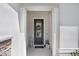 The front door is framed by white columns and decorated with a welcoming wreath and lantern at 14184 Samoa Hill Ct, Riverview, FL 33569