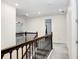 Upstairs hallway with carpet floors and wood banister at 14184 Samoa Hill Ct, Riverview, FL 33569