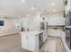 Modern kitchen with an island, stainless steel appliances, and open floor plan at 14184 Samoa Hill Ct, Riverview, FL 33569