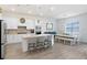 Bright, open kitchen featuring white cabinets, an island, and stainless steel appliances at 14184 Samoa Hill Ct, Riverview, FL 33569