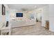 Open concept living room with a large sofa, wood floors, and access to other rooms at 14184 Samoa Hill Ct, Riverview, FL 33569