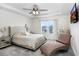 The main bedroom includes a comfortable chaise lounge, ceiling fan, large window, and decorative lighting at 14184 Samoa Hill Ct, Riverview, FL 33569