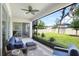 Inviting outdoor patio with comfortable seating, ceiling fan, and serene backyard views at 14184 Samoa Hill Ct, Riverview, FL 33569