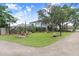 Relaxing community recreational area featuring Adirondack chairs, a cornhole game, and shaded seating at 14184 Samoa Hill Ct, Riverview, FL 33569
