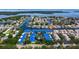 An overhead shot showcases the neighborhood and a building with a blue roof near the ocean at 1625 Watermark Ne Cir, St Petersburg, FL 33702