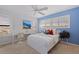 This bedroom features a white frame bed, a desk with chair, and light blue accent wall at 1625 Watermark Ne Cir, St Petersburg, FL 33702