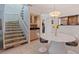 Open dining area with staircase, modern light fixture, and adjacent kitchen at 1625 Watermark Ne Cir, St Petersburg, FL 33702