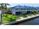 Waterfront property with lush landscaping, patio, and private dock access, offering serene coastal living at 1625 Watermark Ne Cir, St Petersburg, FL 33702
