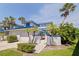 Charming two-story waterfront home featuring a blue roof, manicured landscaping, and a private entrance at 1625 Watermark Ne Cir, St Petersburg, FL 33702