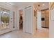 Bright foyer featuring tile floors, a decorative glass door, and access to a powder room and kitchen area at 1625 Watermark Ne Cir, St Petersburg, FL 33702