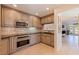 A bright kitchen features tile floors and countertops with light stained wood cabinetry at 1625 Watermark Ne Cir, St Petersburg, FL 33702