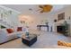 Bright living room with tile flooring, fireplace, and a unique decorative ceiling fan at 1625 Watermark Ne Cir, St Petersburg, FL 33702