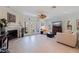 Bright living room with a fireplace, tiled floor, ceiling fan and view of the backyard with waterfront access at 1625 Watermark Ne Cir, St Petersburg, FL 33702