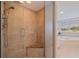 Walk-in shower featuring a seat and clear glass door, adjoining the large tub in the Primary bathroom at 1625 Watermark Ne Cir, St Petersburg, FL 33702