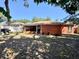Backyard featuring a well-maintained lawn, a screened in porch, and mature trees at 1813 Landside Dr, Valrico, FL 33594