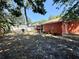 View of the home's backyard, featuring a grill and screened in porch at 1813 Landside Dr, Valrico, FL 33594