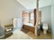 Well-lit bathroom showcasing a tub with decorative tile surround, a showerhead, and a toilet at 1813 Landside Dr, Valrico, FL 33594