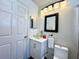 Well-lit bathroom featuring a glass bowl sink, modern vanity, and decorative mirrors at 1813 Landside Dr, Valrico, FL 33594