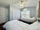 Bedroom featuring wood floors, ceiling fan and a large window at 1813 Landside Dr, Valrico, FL 33594