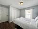 Bedroom showcases wood-look floors, closet, and a window dressed with light and airy white curtains at 1813 Landside Dr, Valrico, FL 33594