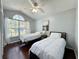 Cozy bedroom with two twin beds, ceiling fan and large window at 1813 Landside Dr, Valrico, FL 33594