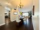 Open-concept dining room with elegant chandelier and view of the living room at 1813 Landside Dr, Valrico, FL 33594