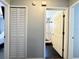 Hallway showcasing closet and bathroom with white-tiled shower and black-hex tile floor at 1813 Landside Dr, Valrico, FL 33594