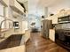 Modern kitchen with stainless steel appliances, including a refrigerator and oven, complemented by stylish countertops at 1813 Landside Dr, Valrico, FL 33594