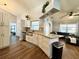 Bright kitchen featuring stainless steel appliances, white cabinets, a modern sink, and a view into the living area at 1813 Landside Dr, Valrico, FL 33594
