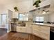 Contemporary kitchen with white cabinets, stainless steel appliances, and a stylish sink with a pull-down faucet at 1813 Landside Dr, Valrico, FL 33594