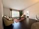 Cozy living room featuring hardwood floors, plush seating, and natural light from a large window at 1813 Landside Dr, Valrico, FL 33594