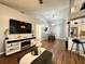 Open living room with vaulted ceiling, wood flooring and modern entertainment center with fireplace at 1813 Landside Dr, Valrico, FL 33594
