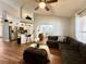 Spacious living room with wood floors, opening to kitchen with breakfast bar and stainless appliances at 1813 Landside Dr, Valrico, FL 33594