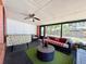 Enclosed porch is the ideal spot for relaxation with comfortable furniture and pleasant natural light at 1813 Landside Dr, Valrico, FL 33594